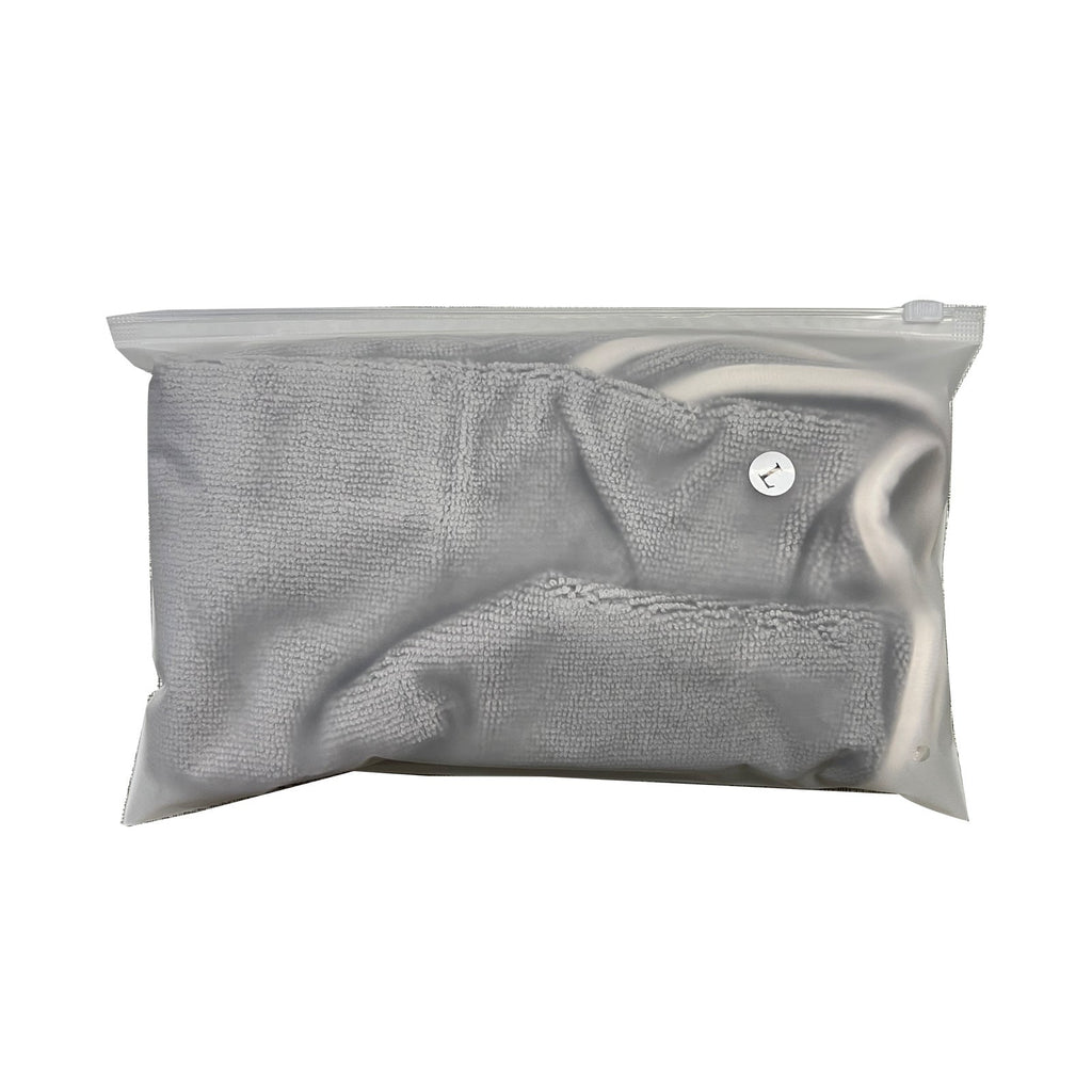Grey microfibre drying robe folded in its storage bag