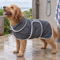 Wet caramel Groodle wearing the charcoal grey microfibre drying robe